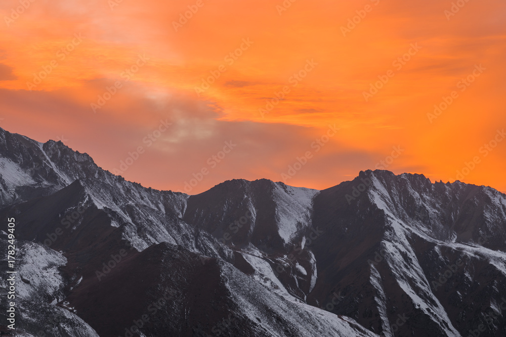 orange sunset over the mountain peaks