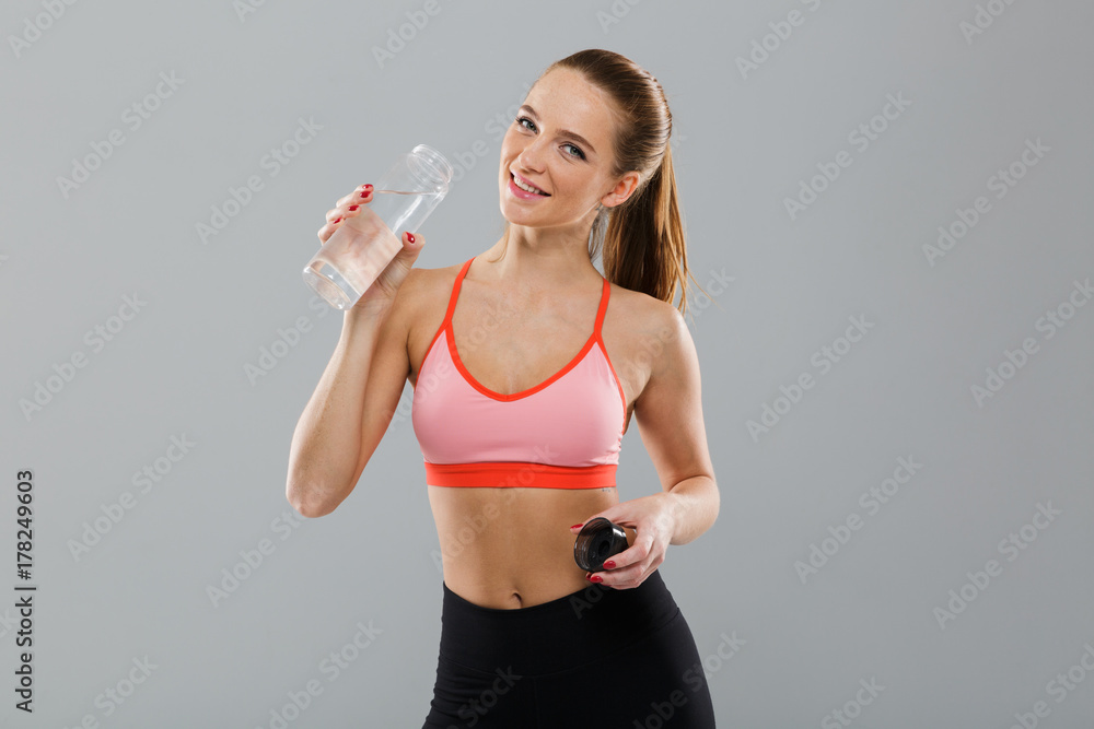 Portrait of smiling young sports girl holding water bottle Portrait of smiling young sports girl holding water bottle