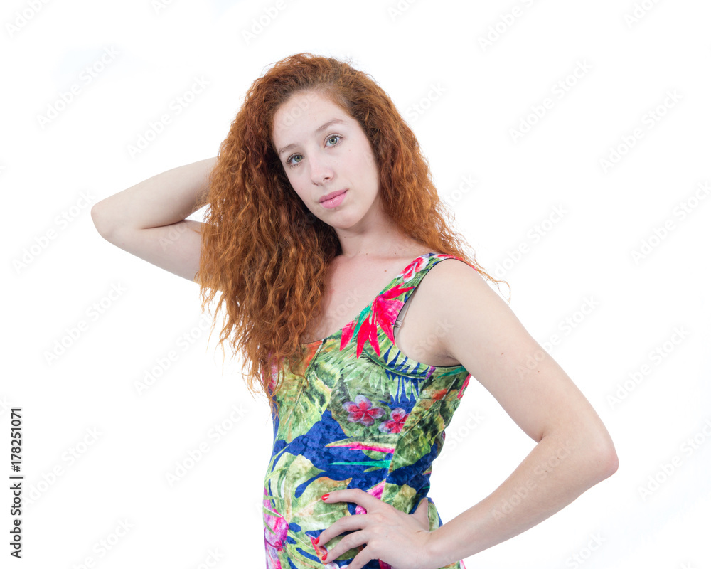 Woman makes pose for photograph. Portrait. Redhead teenager with wavy hair. Tropical clothing.. Woman makes pose for photograph. Portrait. Redhead teenager with wavy hair. Tropical clothing..