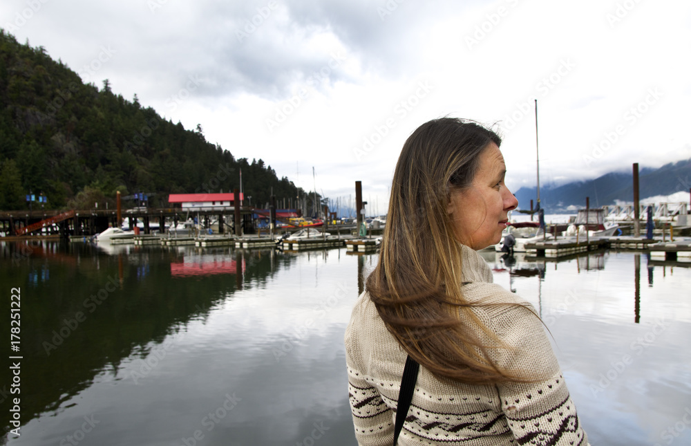 Middle-Aged Caucasian Woman in Westcoast Cowichan Jacket Waits at Local Fishing Marina