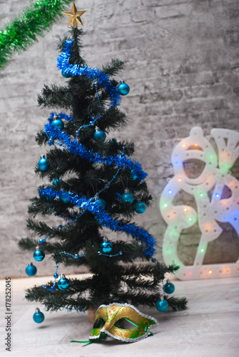 carnival mask under the Christmas tree. photo