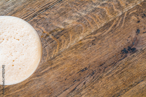 Coffee cup Cappuccino on old wooden table, top view.