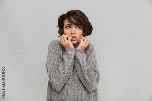 Nervous young woman dressed in sweater