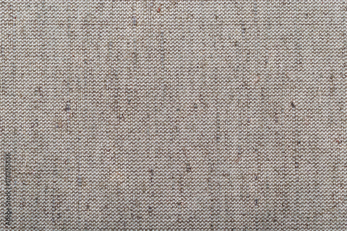 Rough texture of linen cloth. Close-up. The fabric is made of natural ingredients. Cotton grey fabric. photo