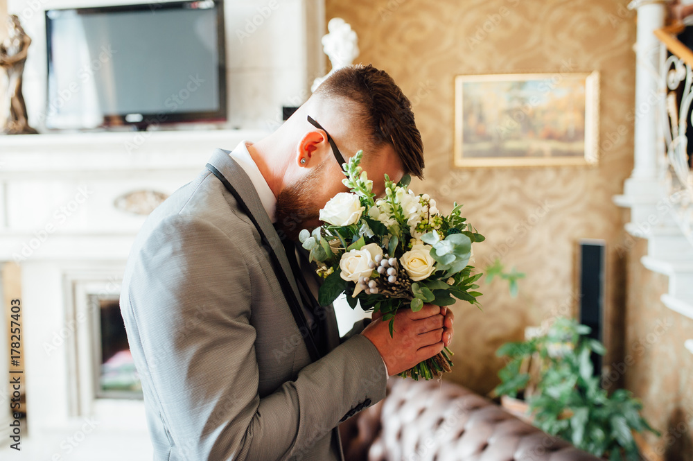 stylish groom holding bridal bouquet stylish groom holding bridal bouquet