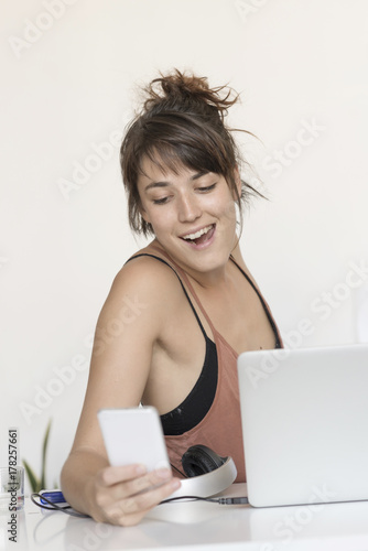 Young and pretty startup worker using a moblie phone © 2Design