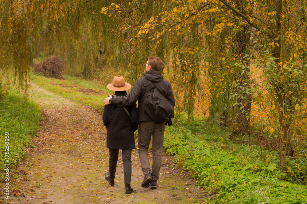 couple of tourist walking having good time in autumn park couple of tourist walking having good time in autumn park