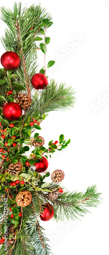 Holiday garland with red ornaments  pine   spruce branches  pine cones and evergreen with berries  Common Bearberry Kinnikinnick 