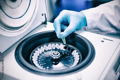 Close up of a chemist using a centrifuge photo