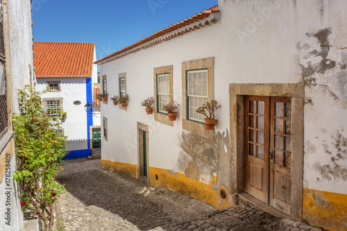 Historic Portuguese village of Obidos and narrow streets with cobblestone.