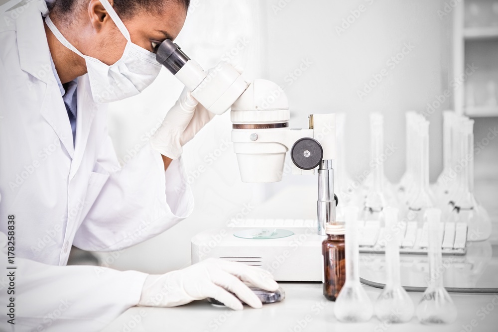 Scientist working on microscope Scientist working on microscope