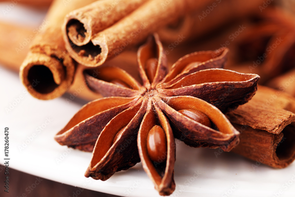 Fragrant star anise and cinnamon on wooden table.