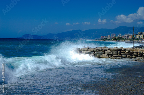 Waves break about a stone pier