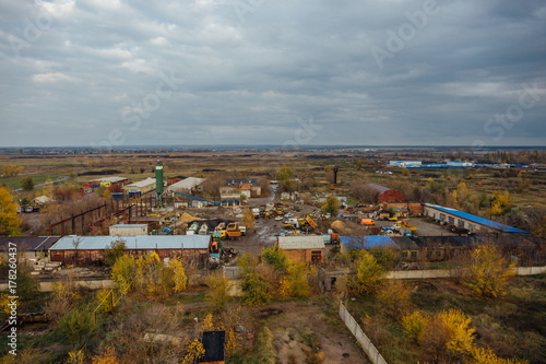 Aerial view of abandoned industrial park zone from above, concrete buildings, industry and agricultural district