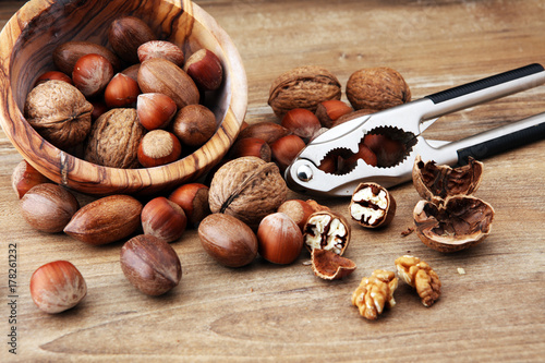 Large diversity of healthy nuts in wooden bowl.