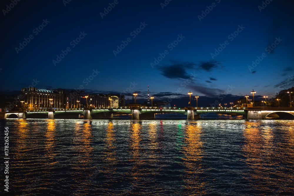 Bridge in Saint-Petersburg with lights illumination in summer white night, Neva river