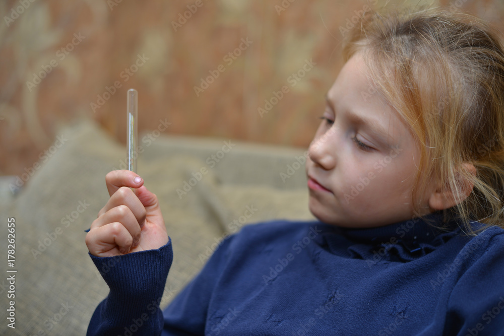 Close-up thermometer measuring temperature with pills on the background Close-up thermometer measuring temperature with pills on the background