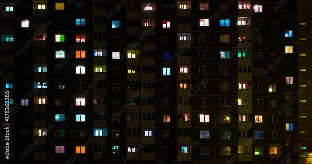 Light in the windows of a multistory building. Time lapse