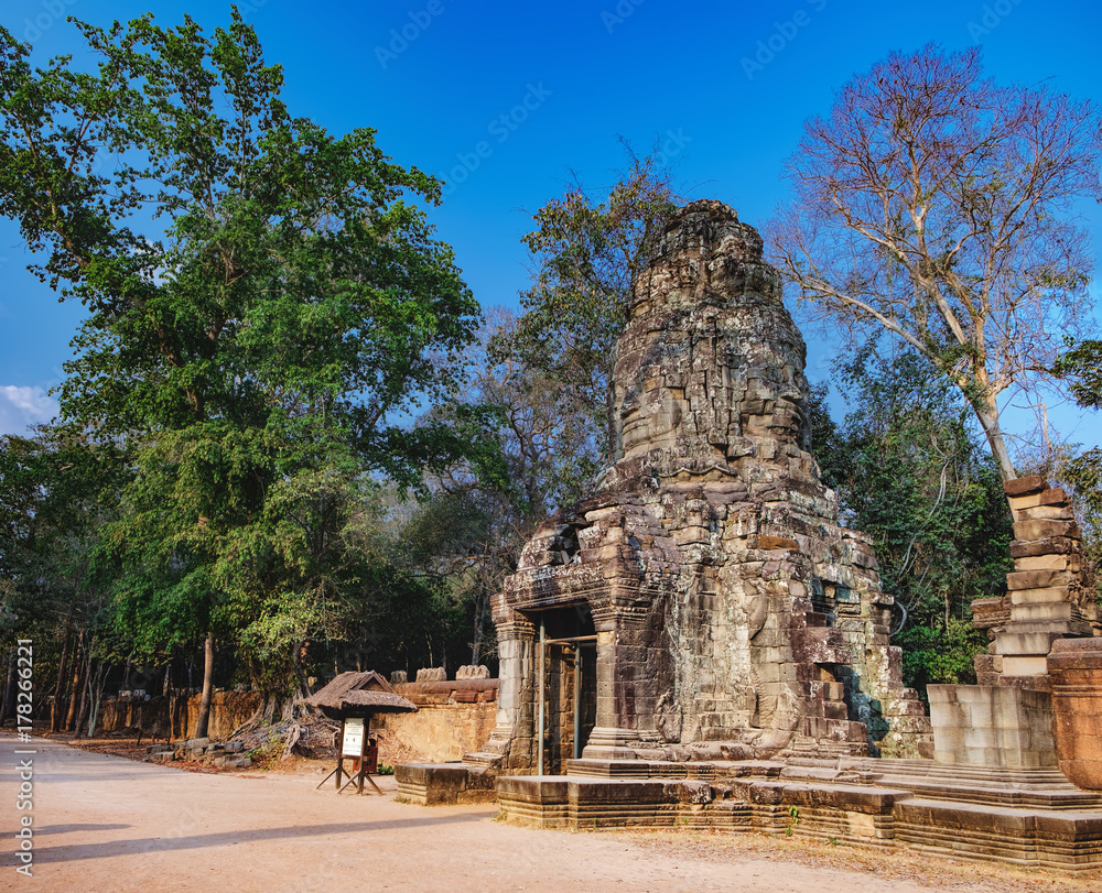 Main entrance to Ta Prohm Temple in Angkor Complex, Siem Reap, Cambodia. Giant trees grow among the ruins of ancient Khmer architecture, World Heritage