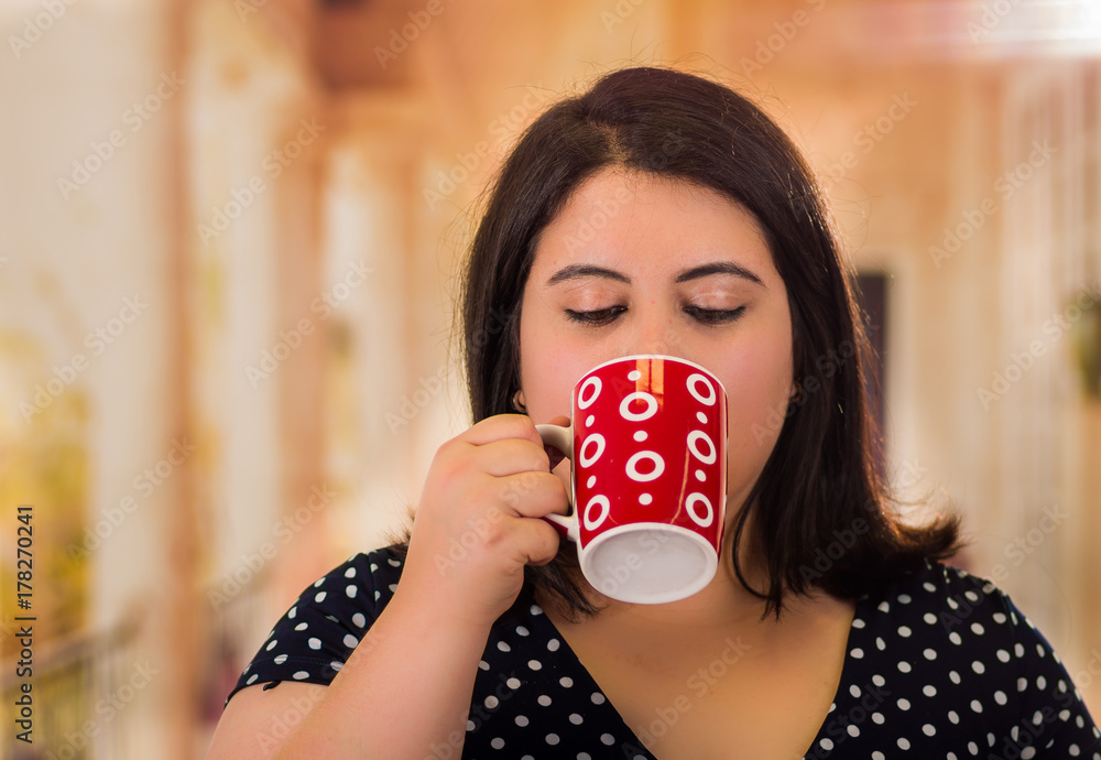 Portrait of pretty fat woman in a beautiful dress, dra cup of coffe in a blurred background Portrait of pretty fat woman in a beautiful dress, dra cup of coffe in a blurred background