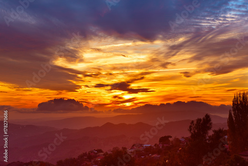 Amazing mountain landscape with colorful vivid sunset on the bright sky, natural outdoor travel background © Roxana