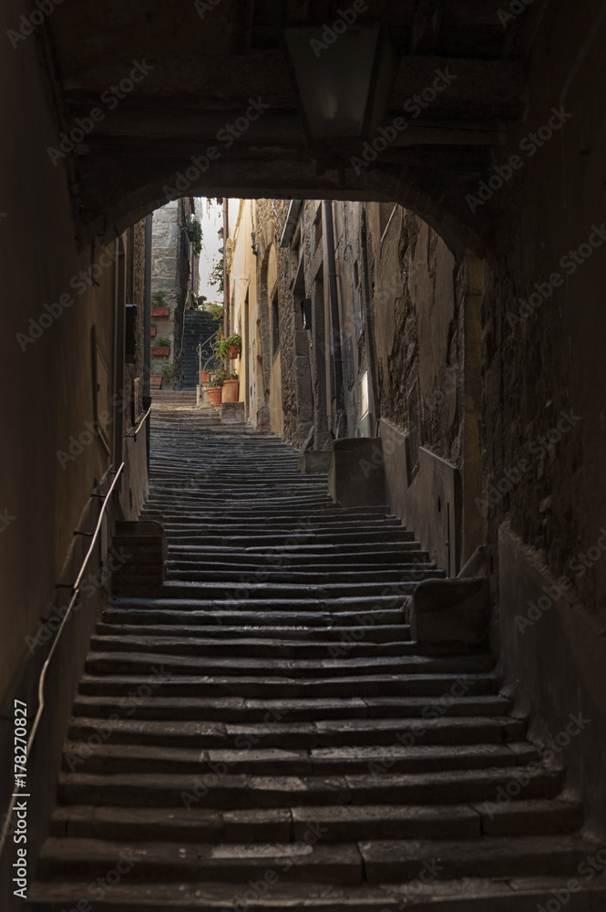 Beautiful street of captivating medieval town of Cortona in Tuscany, Italy. It is an ancient Etruscan hill town, full of narrow steep streets, intimate piazzas, stunning artwork and historical museums
