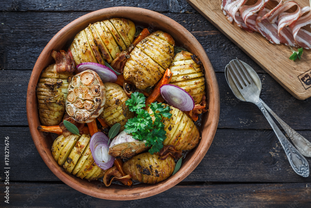 Baked potato with garlic on a dark background. Flat lay. Top view. Baked potato with garlic on a dark background. Flat lay. Top view.