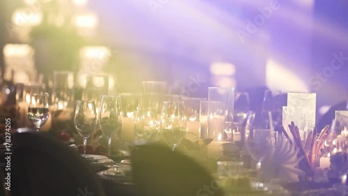 Decorative candles on the dining table, glasses and Christmas candles on the table, white wax candleswith glass candlestick, Candle with Glass Candlestick, restaurant, interior, close-up photo