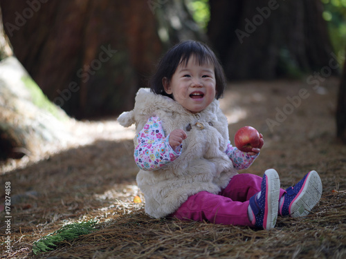 Baby girl playing at Autumn outdoor park photo