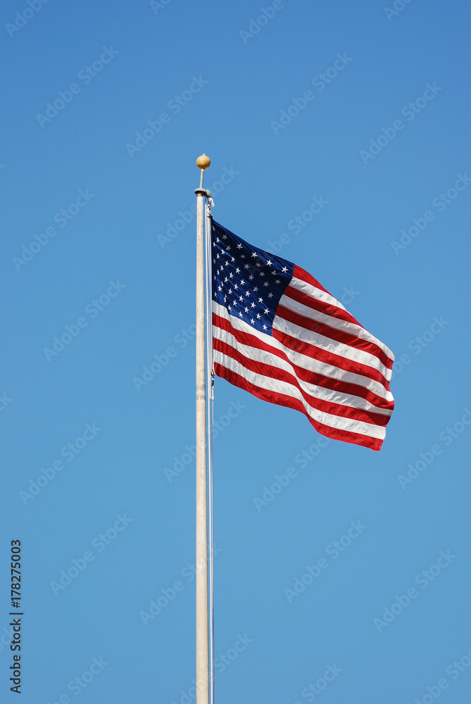 Waving USA flag at flag pole 