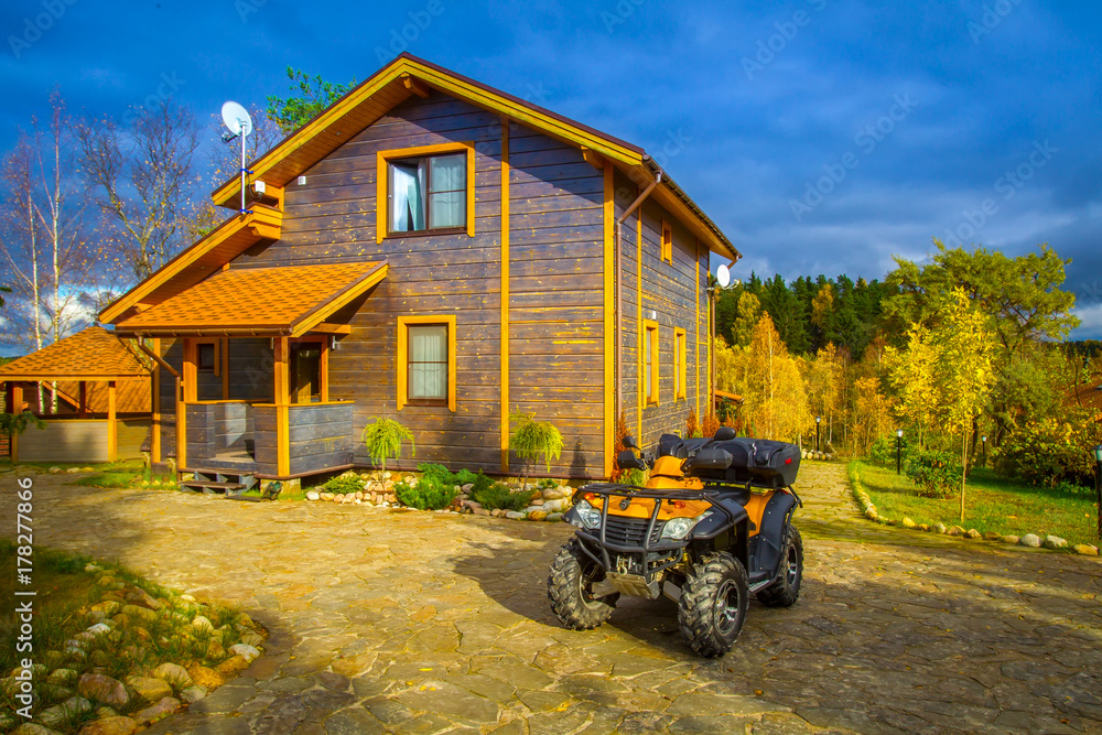 Ταπετσαρία ATV quadbike is near the cottage. ATV quadbike. Vacation home.