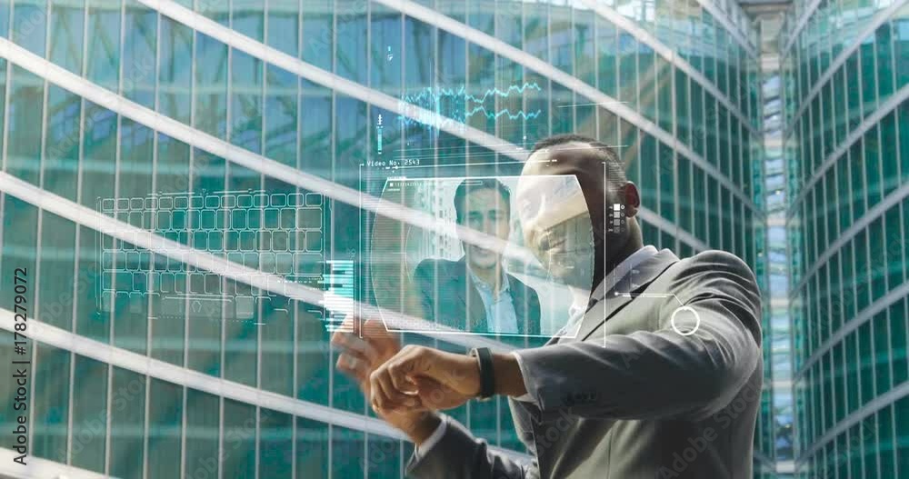 An African-American businessman touches his hand to see the financial holographic trends in holography appearing in front of him. Concept of: augmented reality and future An African-American businessman touches his hand to see the financial holographic trends in holography appearing in front of him. Concept of: augmented reality and future