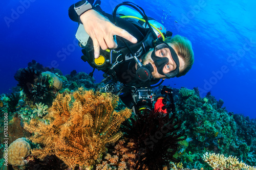 Happy SCUBA diver on a beautiful tropical coral reef