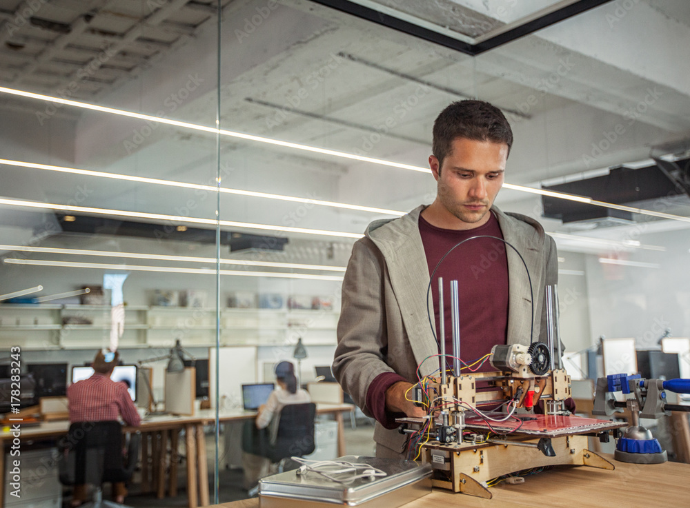 Designer Working at a 3D Printer Designer Working at a 3D Printer