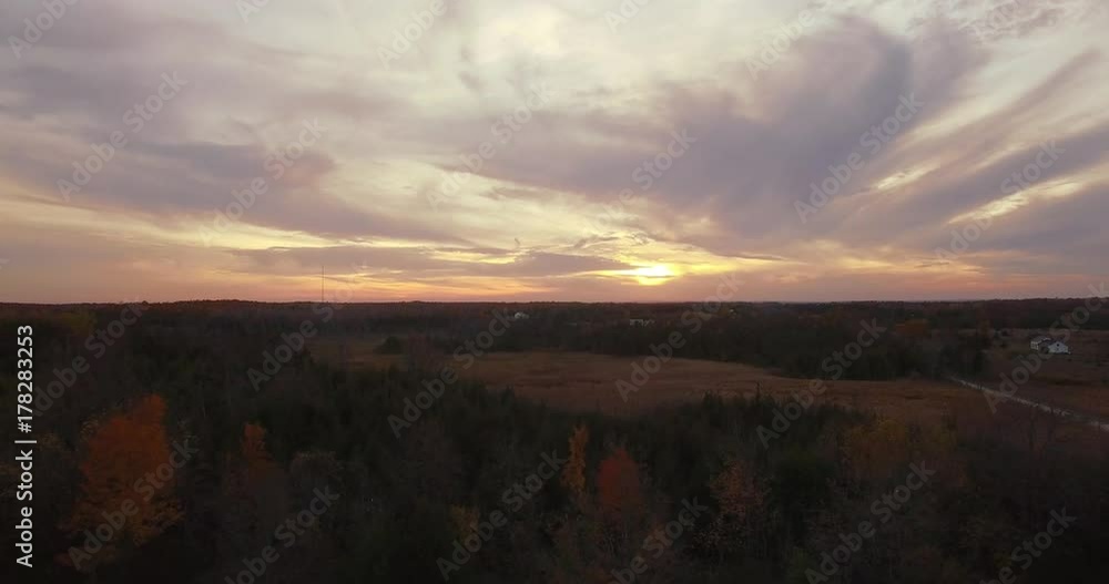 Rising reveal of brilliant sunset and sky over farmland. Rising reveal of brilliant sunset and sky over farmland.