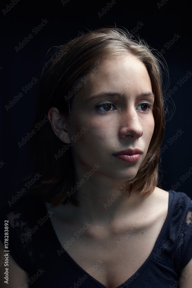 Young woman dramatic portrait with black background Young woman dramatic portrait with black background