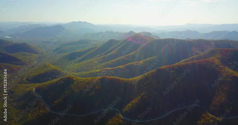 Amazing aerial view of the hills and small mountains covered with green endless forests. Beautiful sky with white clouds. Russia Amazing aerial view of the hills and small mountains covered with green endless forests. Beautiful sky with white clouds. Russia