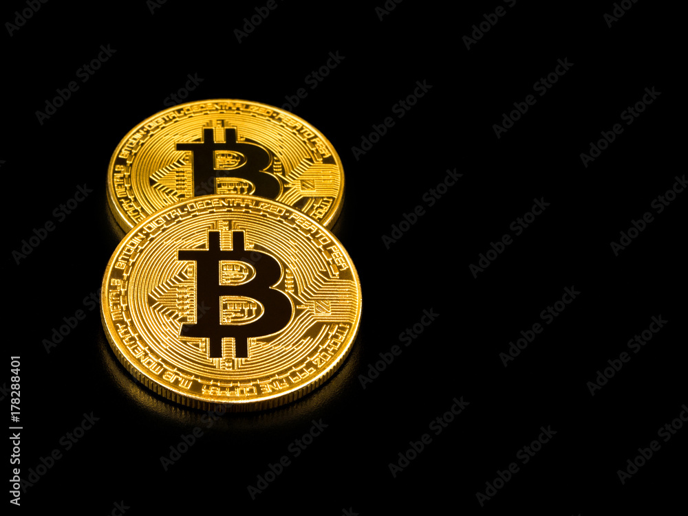 Golden bitcoin on black background. Bitcoin cryptocurrency. Golden bitcoin on black background. Bitcoin cryptocurrency.
