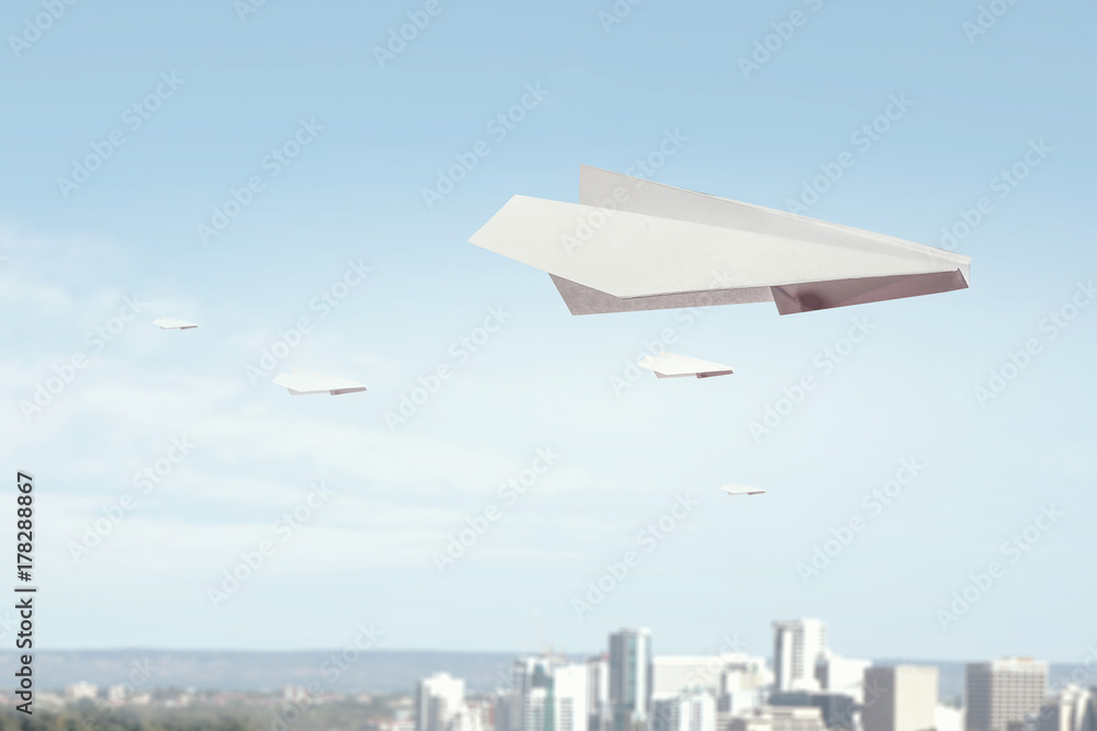 Fototapeta premium Origami plane flying in sky. Mixed media