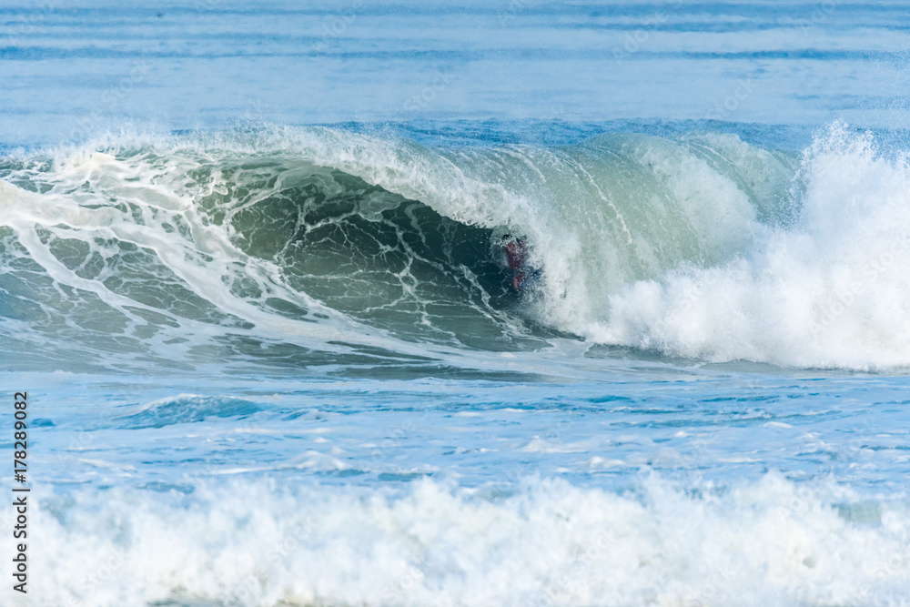 Bodyboarder surfing ocean wave Bodyboarder surfing ocean wave