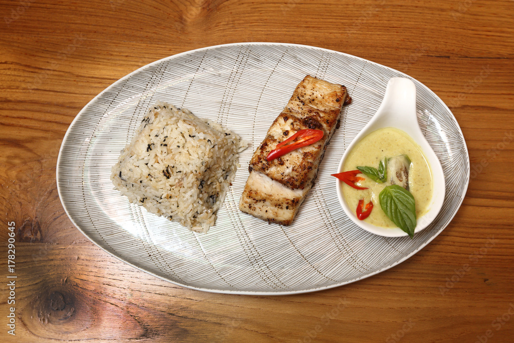 Grill Salmon Fish Green Curry Organic Steam Rice in Good Arrange by Food Stylish, oval dish plate wooden table, top view Grill Salmon Fish Green Curry Organic Steam Rice in Good Arrange by Food Stylish, oval dish plate wooden table, top view