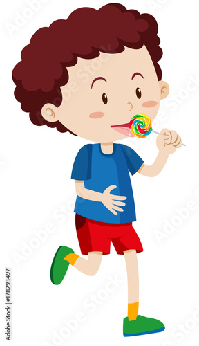 Little boy eating lollipop
