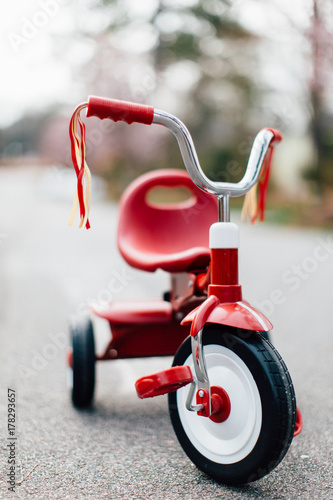 A tricycle parked in the middle of a street photo