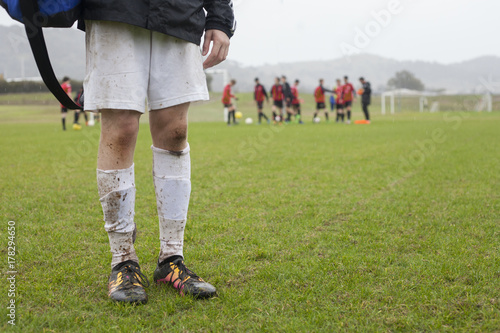 Muddy football player on field