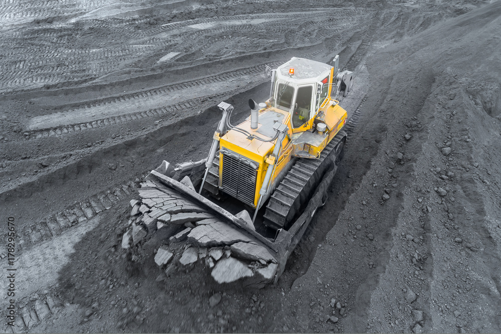 Open pit mine, breed sorting. Mining coal. Bulldozer sorts coal. Extractive industry, anthracite. Coal industry. Open pit mine, breed sorting. Mining coal. Bulldozer sorts coal. Extractive industry, anthracite. Coal industry.