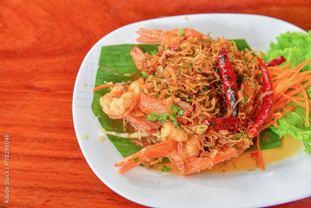 Thai-Style Prawns with Tamarind Sauce on Wooden Table Thai-Style Prawns with Tamarind Sauce on Wooden Table