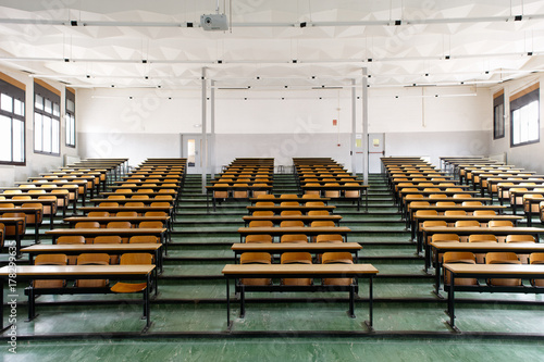 Empty auditorium of an old school with a green floor photo