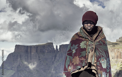 A portrait of a black Basotho shepherd wrapped in a traditional blanket. photo