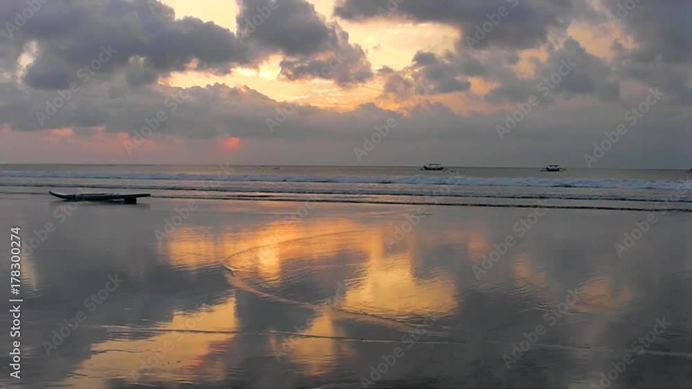 The sunset sky is reflected in the mirror beach of Kuta. The island of Bali. Indonesia. The sunset sky is reflected in the mirror beach of Kuta. The island of Bali. Indonesia.
