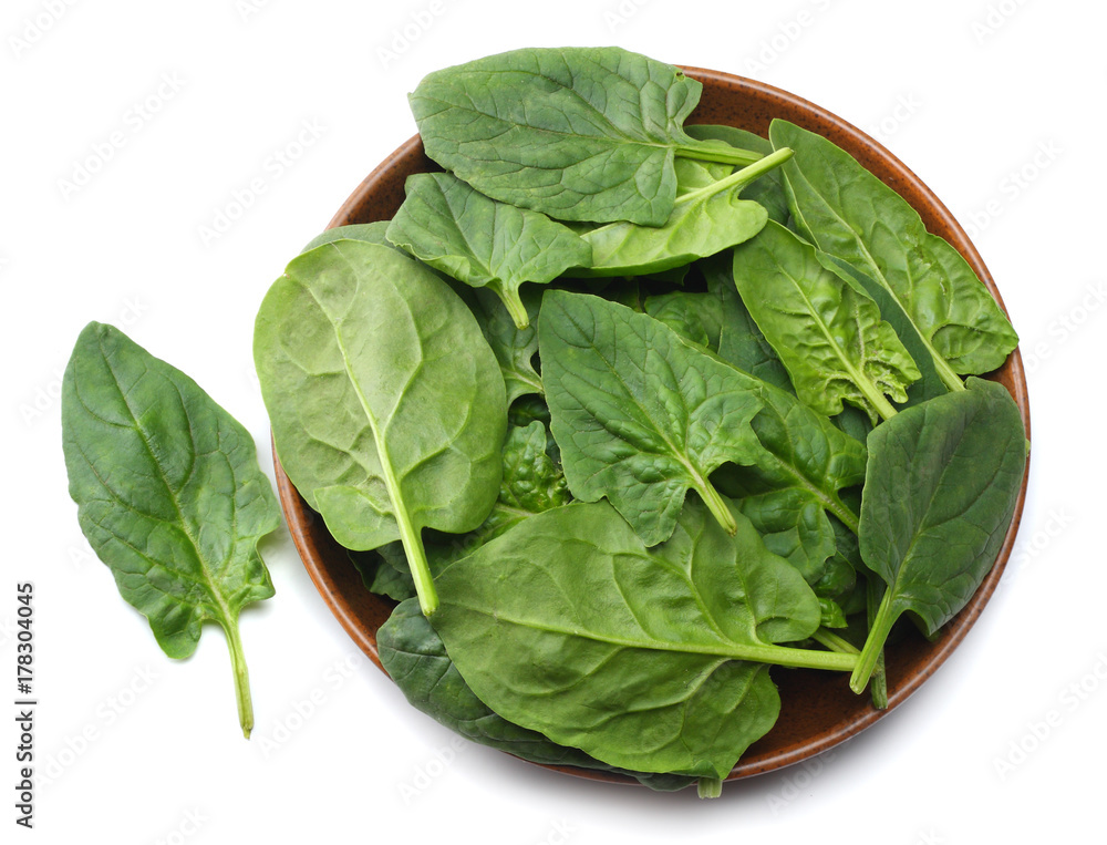spinach leaves in bowl isolate on white background top view spinach leaves in bowl isolate on white background top view